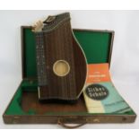 A good quality Austrian Zither in fitted case with tuning key and music books. Condition report: