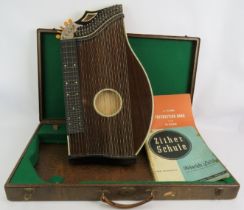 A good quality Austrian Zither in fitted case with tuning key and music books. Condition report: