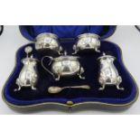 A 5 piece silver condiment set comprising of 2 salts, 2 peppers and mustard pot. Birmingham 1913,
