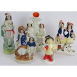 Four 19th century Staffordshire pottery flat back figurines and a Coalport figurine of Paddington