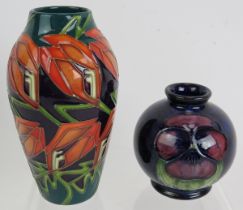 A small 1930s/40s Moorcroft pottery small squat vase in Pansy design and a contemporary Moorcroft