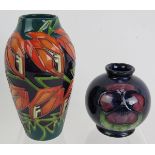 A small 1930s/40s Moorcroft pottery small squat vase in Pansy design and a contemporary Moorcroft