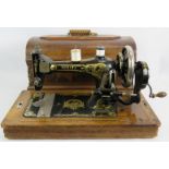 A vintage Serata manual sewing machine with wooden case, key and instructions. Condition report: