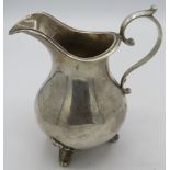 A Victorian silver cream jug with round bellied body and scroll feet. Approx: 5" high. London