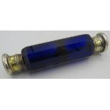 A double ended blue glass scent/smelling salts bottle with white metal tops. Condition report: One