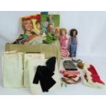 A large box full of 1970s handmade Cindy Doll outfits with some patterns and two Cindy dolls, one