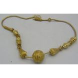 A yellow metal Indian type necklace known as "Gold Vermeil" which is basically a base metal of