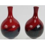 A pair of Royal Doulton red flambé veined vases, No 1606, 11.5cm tall. Condition report: Both have