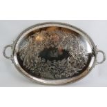 A large Victorian silver plated oval tray with engraved detail and family crest to centre. Marked