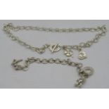 A white metal chain link necklace with heart and four leaf clover charm. Heart marked 925. Marked