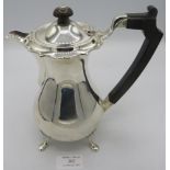 A silver hot water jug on pad feet. Ebonised handle & finial, approx 8" high, Birmingham 1939.