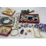 A large collection of mainly costume jewellery, to include: an amethyst pendant on a white metal