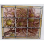 An Arts and Crafts stained glass leaded panel hand decorated with apples in a tree. 40cm x 48cm.