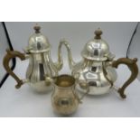 A silver teapot and matching coffee pot with plain round bellied body and hinged lids. Teapot.