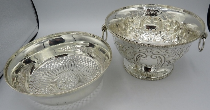 A silver plated embossed rose bowl with ring handles and a silver plated strainer bowl. Condition