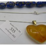 A venetian milliflora blue glass bead necklace with yellow metal hook clasp and an amber style heart