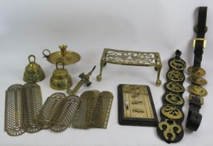A lot of mixed brassware including a cribbage board and pegs, 2 bells, 7 fretwork finger plates,