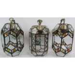 A pair of hexagonal Arts and Crafts style modern ceiling lanterns with bevelled glass and amber