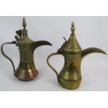 A finely decorated antique copper and brass middle Eastern Dallah coffee pot and a similar brass