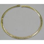 A 14ct yellow and white gold reversible necklace. The flat circular necklace has an inset diamond on