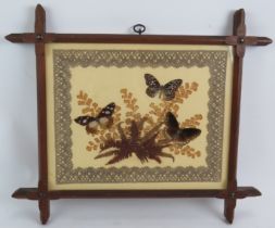 A 1930s collage of three butterflies on ferns bordered by a lace edging in a Black Forest style pine