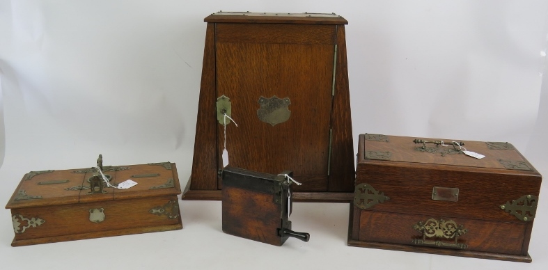 An Edwardian oak smokers cabinet with plated mounts, two similar cigar/cigarette boxes and an