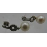 A pair of 9ct white gold diamond and pearl drop earrings. Diamonds 0.16cts. Boxed. Condition report: