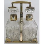 A silver plated two decanter tantalus by WMF, c1930. Plated stand with key operated sprung mechanism