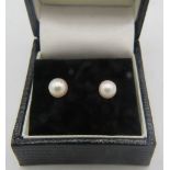 A pair of pearl earrings with 14ct yellow gold backs. Each pearl approx: 5mm x 5mm. Boxed. 1 gram.