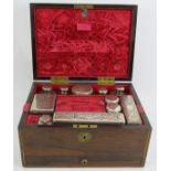 A fine Regency Rosewood toilet box, fully fitted in red velvet with hallmarked silver topped jars,