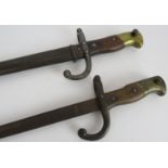 Two late 19th/early 20th century French bayonets one with steel scabbard. Both numbered and with