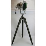 An aluminium PAR 64S theatre light with green lens mounted on a vintage green wooden adjustable