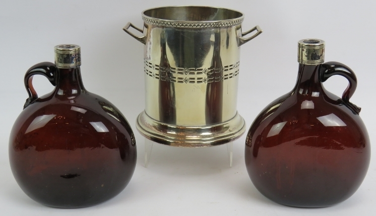 An antique silver plated bottle coaster marked M&Co and two 19th century brown glass flasks with