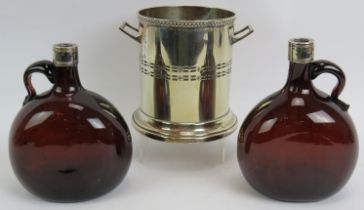 An antique silver plated bottle coaster marked M&Co and two 19th century brown glass flasks with
