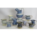 Ten mainly 19th century blue and white Spongeware pottery jugs, tallest 24cm. (10). Condition