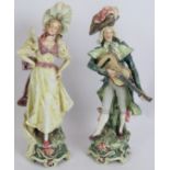 A pair of 19th century continental Majolica figurines of a lady and a minstrel. Both with incised