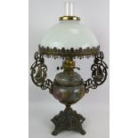 A highly decorative oil lamp with relief moulded pottery reservoir cast brass stand and opaline