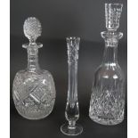 A Waterford crystal decanter in Lismore pattern, an ovoid cut glass decanter with swag pattern and a