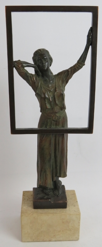 A contemporary bronzed sculpture of a woman at a window mounted on a stone plinth. Signed Miro,