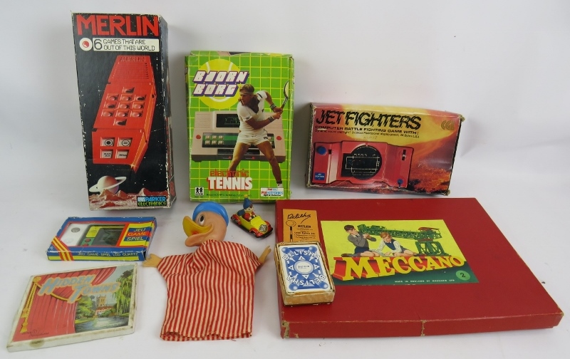 A mixed lot of vintage games, including Bjorn Borg tennis, Merlin, Jet fighters, Meccano, Belisha