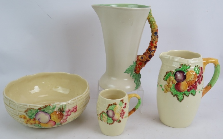 A Clarice Cliff 672 My Garden jug, an 883 pattern fruit bowl and two A J Wilkinson fruit and trellis