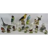 A collection of 21 mixed pottery and porcelain bird figurines including Beswick, Royal Doulton,