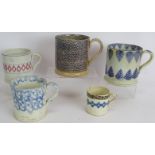 Five 19th century Spongeware pottery mugs of varying size. Largest 13cm tall. (5). Condition report: