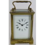 A brass cased 8 day carriage clock with white enamel dial. Height 14cm. Condition report: No key,