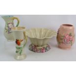 Four pieces of Clarice Cliff hand decorated relief moulded pottery including a large fluted bowl.