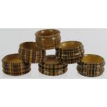 Six mixed Tunbridge ware Treen napkin rings of various size and woods. (6). Condition report: No
