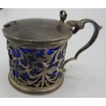 A drum shaped mustard pot with openwork sides and blue liner. Chester 1907. Condition report: Some