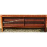 A mid-century tropical hardwood low glazed bookcase with glass sliding doors and height adjustable