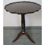 A 19th century mahogany piecrust occasional table, on a tapering turned column with tripod base.