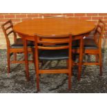A mid-century teak circular dining table by McIntosh, with central butterfly leaf extension, on